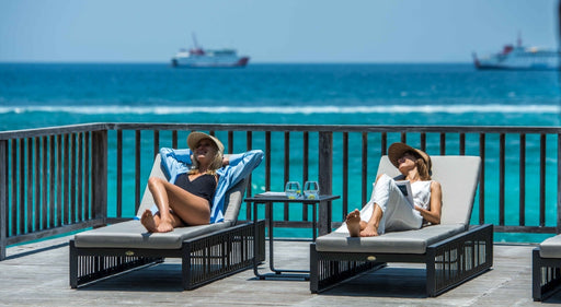 Two ladies relaxing on the Horizon Sun Loungers